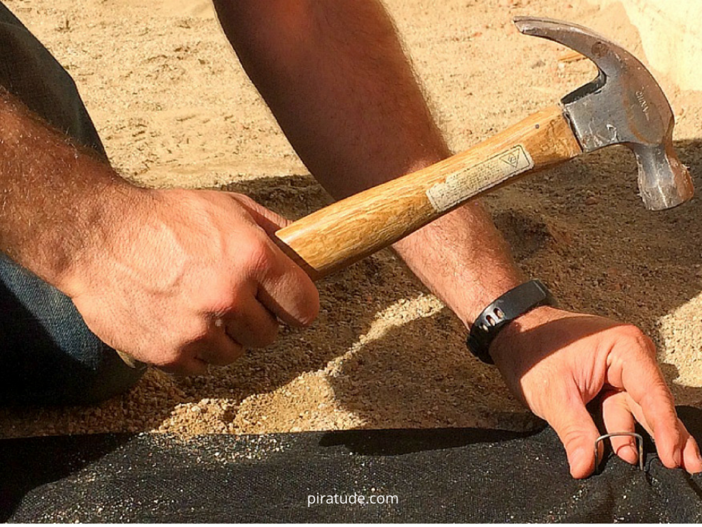 hammer-staple-landscape-fabric-coastal-backyard